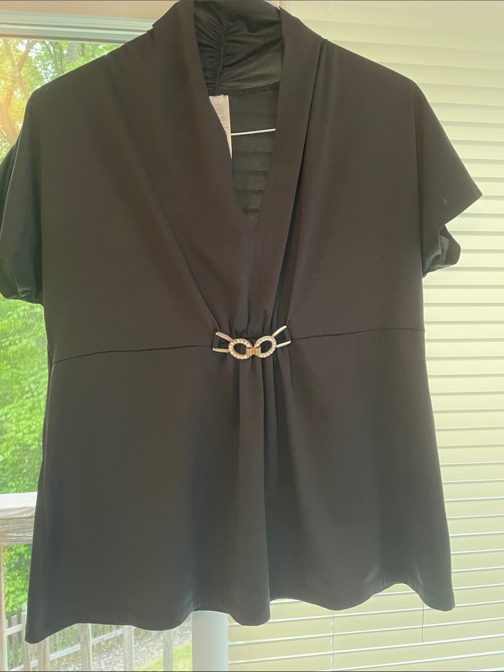 Flattering & Elegant Black V-Neck Women's Top with Decorative Accent